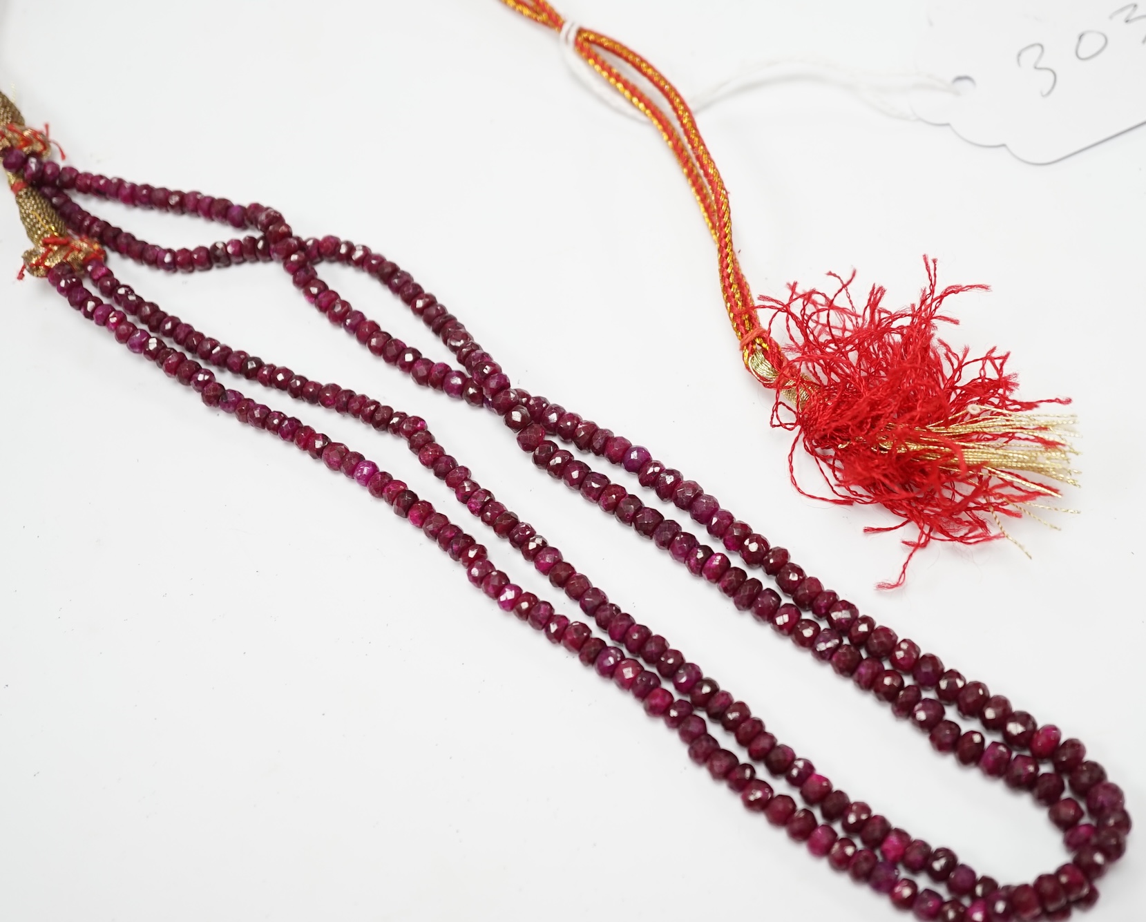 An Indian double strand facetted ruby bead necklace, ruby section only 38cm. Fair condition.